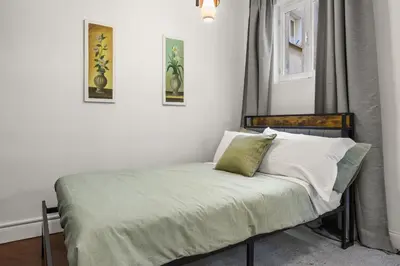 a small bedroom with a bed with white sheets at Betti Classic Home in Rome