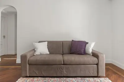 a brown couch with two pillows on it in a living room at Betti Classic Home in Rome