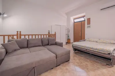 a living room with a couch and a bed at Furi Loft Garden in Rome