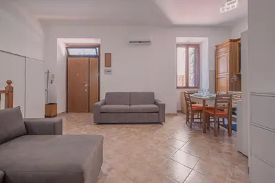 a living room with a couch and a table at Furi Loft Garden in Rome