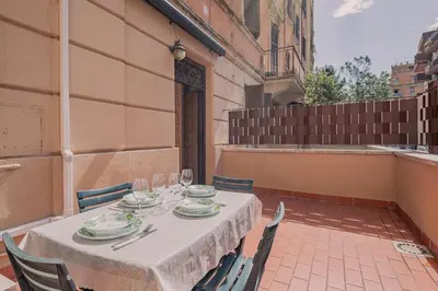 a table with plates and wine glasses on a patio at Furi Loft Garden in Rome