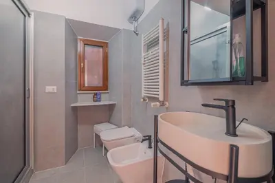 a bathroom with a sink and a toilet at Furi Loft Garden in Rome