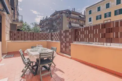 a patio with a table and chairs on a balcony at Furi Loft Garden in Rome