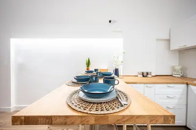 a kitchen with a wooden table with blue dishes on it at Aeterna RHome - Domus Piramide in Rome