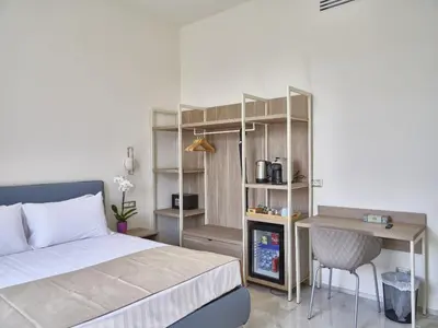a bedroom with a bed and a desk and a table at King Vittorio Guest House in Rome