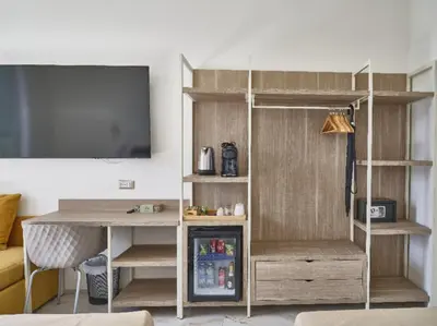 a room with a desk and a tv at King Vittorio Guest House in Rome