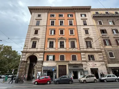 a tall building with cars parked in front of it at King Vittorio Guest House in Rome