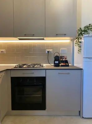 a kitchen with a stove and a refrigerator at Golden Round Palace in Rome