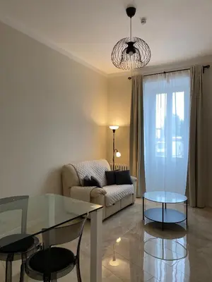 a living room with a couch and a glass table at Golden Round Palace in Rome