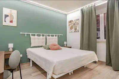 a bedroom with a large bed with a white bedspread at Urbanflat Termini in Rome
