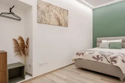 a bedroom with a bed and a painting on the wall at Urbanflat Termini in Rome