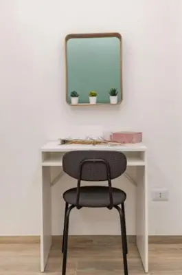 a desk with a chair in front of a mirror at Urbanflat Termini in Rome