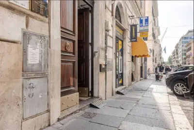 an empty city street with buildings and a car at Urbanflat Termini in Rome