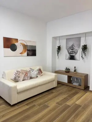 a living room with a white couch and a table at Domus Gregorio VII in Rome
