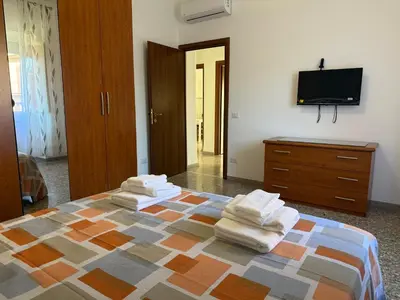 a bedroom with a bed with towels on it at Metro A Battistini - Ramat House in Rome