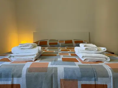 a bedroom with a bed with towels on it at Metro A Battistini - Ramat House in Rome