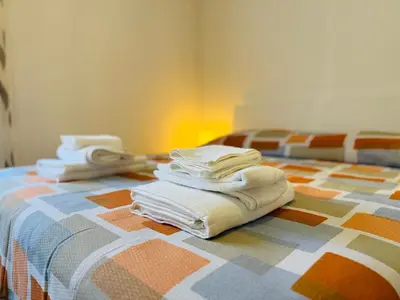 a pile of towels sitting on top of a bed at Metro A Battistini - Ramat House in Rome