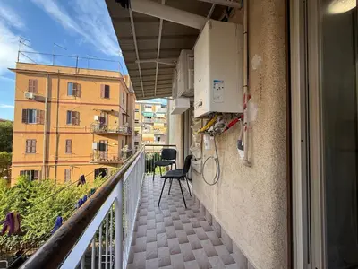 a balcony with a chair sitting on the side of a building at Metro A Battistini - Ramat House in Rome