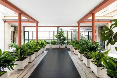 a greenhouse filled with potted plants in a building at Urban Nest - Trastevere by RHR in Rome