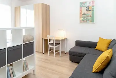 a living room with a couch and a table at Urban Nest - Trastevere by RHR in Rome