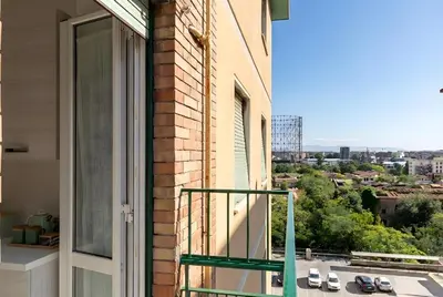a balcony with a view of a city at Urban Nest - Trastevere by RHR in Rome