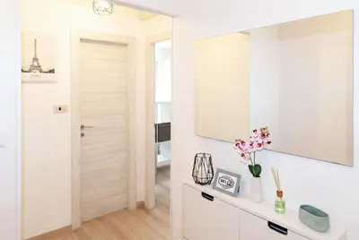 a white bathroom with a mirror and a sink at Urban Nest - Trastevere by RHR in Rome