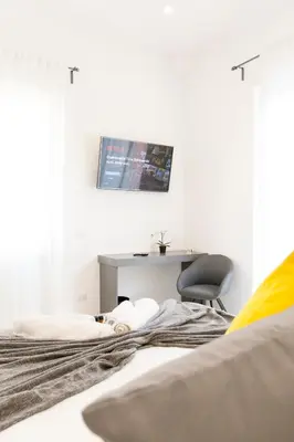a bedroom with a bed with a desk and a chair at Ottavilla Apartment in Rome