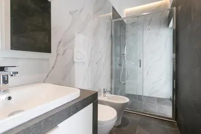 a bathroom with a sink and a toilet and a shower at Ottavilla Apartment in Rome