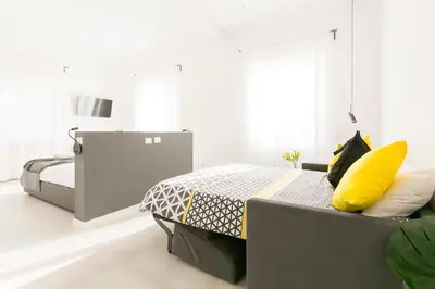 a bedroom with two beds and a yellow pillow at Ottavilla Apartment in Rome