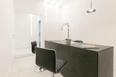 an office with a black desk and chairs at Ottavilla Apartment in Rome