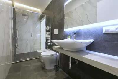 a bathroom with a sink and a toilet and a shower at Ottavilla Apartment in Rome
