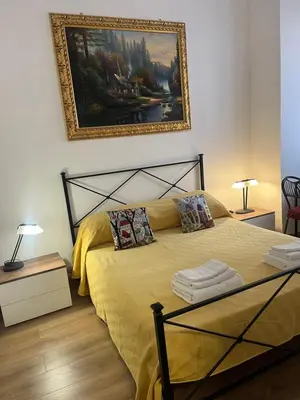 a bedroom with a bed and a painting on the wall at Vatican Artstudio in Rome