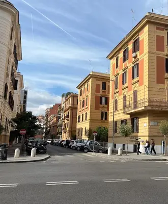 a city street with buildings and cars parked on the street at Vatican Artstudio in Rome