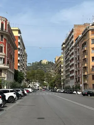 a city street with parked cars and buildings at Vatican Artstudio in Rome