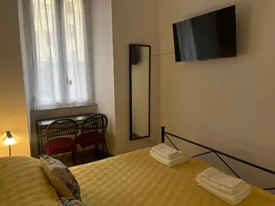 a bedroom with a bed and a flat screen tv on the wall at Vatican Artstudio in Rome