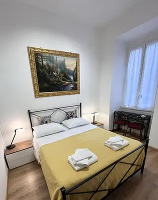 a bedroom with a large bed with towels on it at Vatican Artstudio in Rome