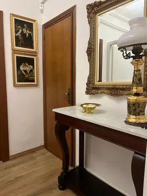 a mirror on a wall next to a table with a mirror at Vatican Artstudio in Rome