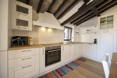 a kitchen with white cabinets and a stove at Roman Dream in Campo de Fiori in Rome