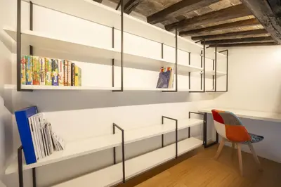 a room with white shelves and a chair at Roman Dream in Campo de Fiori in Rome