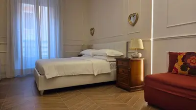 a bedroom with a bed and a lamp and a chair at Luì & Giò Luxury Suite in Rome