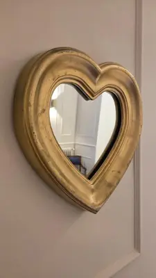 a mirror in the shape of a heart on a wall at Luì & Giò Luxury Suite in Rome