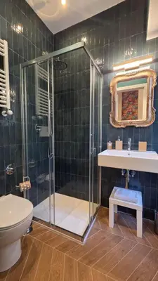 a bathroom with a shower and a sink and a toilet at Luì & Giò Luxury Suite in Rome