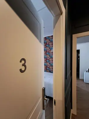 a hallway leading to a bedroom with a bed at Luì & Giò Luxury Suite in Rome