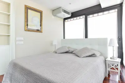 a white bedroom with a white bed with two pillows at Vatican Rome Suites in Rome