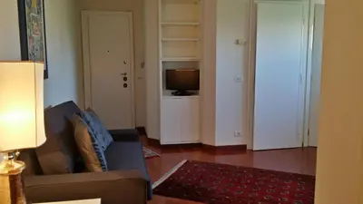 a living room with a couch and a television at Vatican Rome Suites in Rome