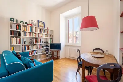 a living room with a blue couch and a table at Casa Medina, Charme in 5 min From Villa Borghese in Rome