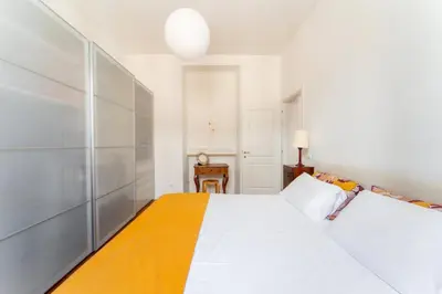 a bedroom with a large white bed and a table at Casa Medina, Charme in 5 min From Villa Borghese in Rome