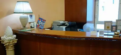 an office with a desk with a lamp on it at Alloggio Positano in Rome