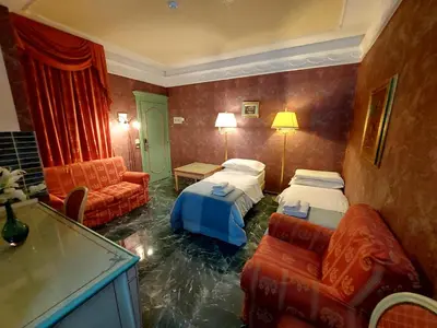 a room with two beds and a living room with water at Alloggio Positano in Rome