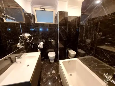 a bathroom with a sink and a tub and a toilet at Alloggio Positano in Rome